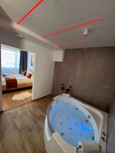 a large bathroom with a tub in the middle of a room at Neo Premium Apartments in Sárvár