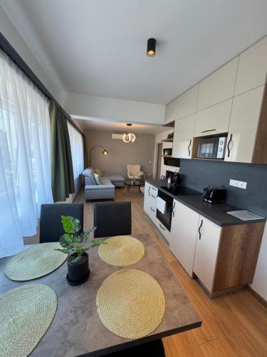 a kitchen and living room with a table and chairs at Neo Premium Apartments in Sárvár