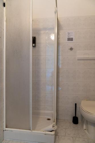 a shower stall in a bathroom with a toilet at Palia's Hotel in Laino Borgo