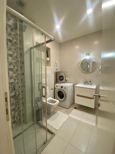 a bathroom with a shower and a toilet and a sink at BASC Modern 2 in Sarajevo