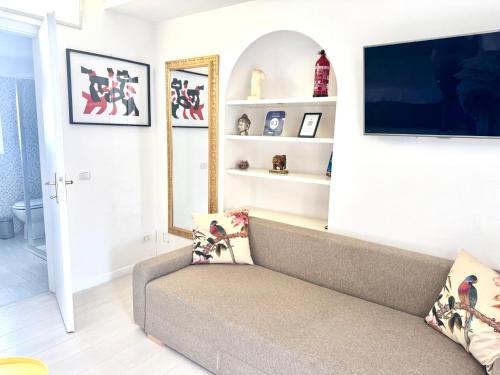 a living room with a couch and a flat screen tv at Flat in Duomo in Milan