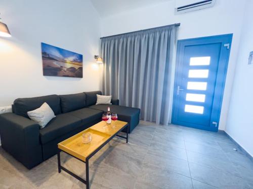 a living room with a couch and a table at Hideaway Thassos in Limenaria