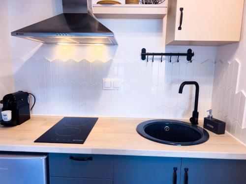 a kitchen with a sink and a stove at Hideaway Thassos in Limenaria