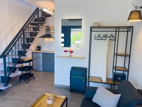 a living room with a couch and a staircase at Hideaway Thassos in Limenaria