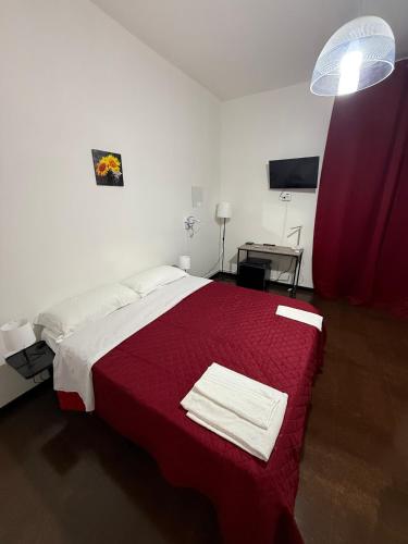 a bedroom with a large bed with a red blanket at Sc Residence Parma in Parma