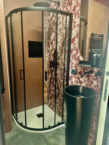 a shower in a bathroom with a trash can at Flat in Duomo in Milan