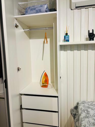 a room with a closet with a dresser and a shelf at Loft 132 Industrial luxury in Mogi das Cruzes