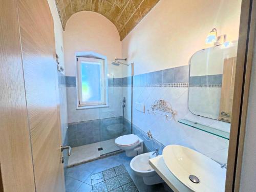 a bathroom with a toilet and a sink and a shower at Casa delle sorgenti in Torre Vado