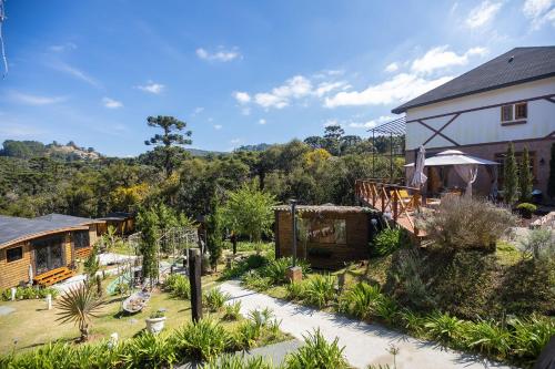 a view of a house and a garden at Pousada Chales da Mantiqueira - Campos do Jordão in Campos do Jordão