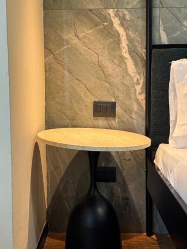 a table in a bedroom with a clock on the wall at Flat in Duomo in Milan