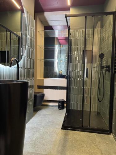 a bathroom with a shower with a glass door at Flat in Duomo in Milan