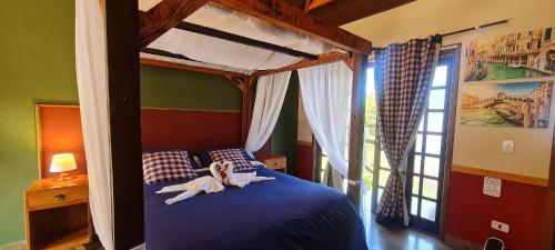 a girl laying on a blue bed in a bedroom at Pousada Chales da Mantiqueira - Campos do Jordão in Campos do Jordão