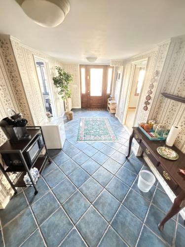 a living room with a large blue tile floor at Modern & Cozy Bedroom with Smart TV, Perfect for Relaxing Getaways in Watchung