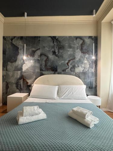 a bedroom with a bed with two towels on it at Flat in Duomo in Milan
