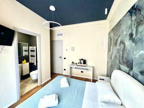 a bedroom with a blue bed and a bathroom at Flat in Duomo in Milan