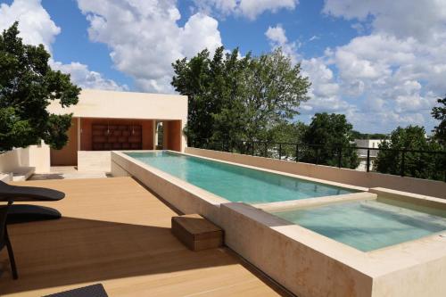 a swimming pool on the roof of a house at Casa Oneiro Hotel Boutique & Suites in Mérida