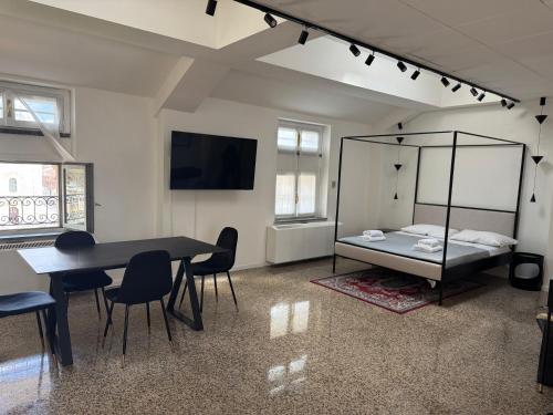 a room with a bed and a table and chairs at Flat in Duomo in Milan