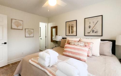 a bedroom with a large bed with white pillows at 183 Beach Club Villa - Fripp Island Coastal Retreat in Fripp Island