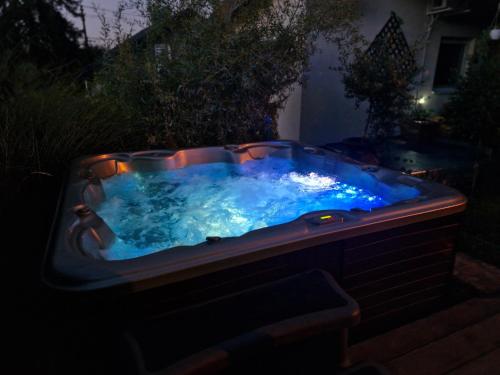 a jacuzzi tub in a yard at night at Vasilija in Sremski Karlovci
