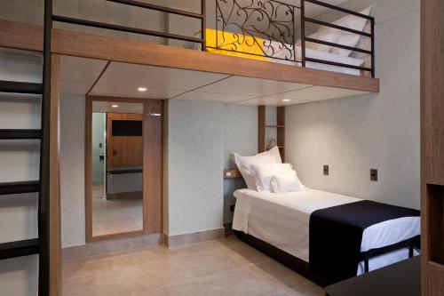 a bedroom with a loft bed with a balcony at LOFT LAPA Baldô in Rio de Janeiro