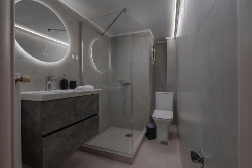 a bathroom with a shower and a sink and a toilet at Angel's Urban Up-ART-ment in Thessaloniki