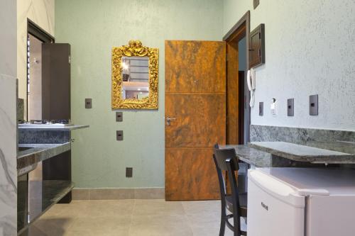 a bathroom with a wooden door and a mirror at LOFT LAPA Baldô in Rio de Janeiro