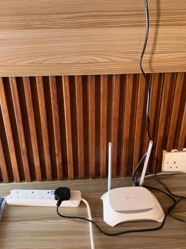 a wooden table with a computer monitor and a router at Kristina Gardens in Voi