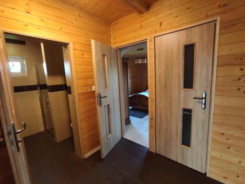 an empty room with two doors and a bedroom at Domek Letniskowy Agroturystyka Motwica 