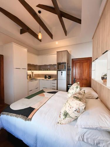 a bedroom with a large bed with pillows on it at Three Anchor Heart in Cape Town