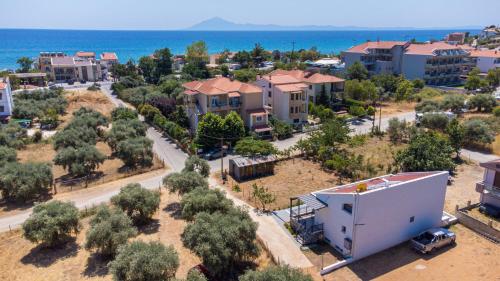 an aerial view of a city with houses and the ocean at Hideaway Thassos in Limenaria