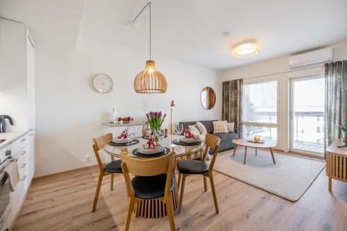 a kitchen and living room with a table and chairs at Unique apartment - Best location with Sauna in Rovaniemi