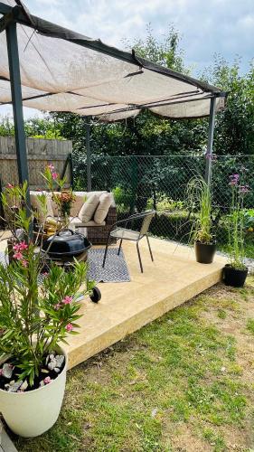 a patio with a table and chairs and an umbrella at Exclusive Garden Oasis with Jacuzzi & Private Parking in Trnava