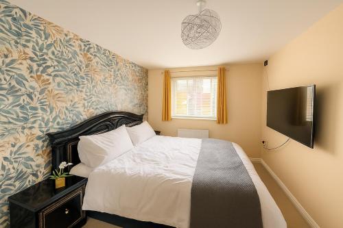 a bedroom with a bed and a television in it at Rosengelyn Apartment in Sheffield