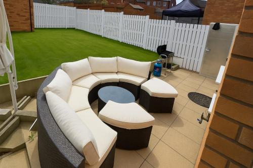 a room with a couch and a table and a grass field at Rosengelyn Apartment in Sheffield