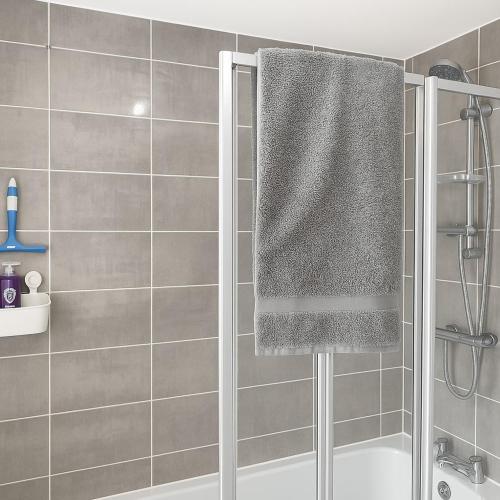 a bathroom with a shower with a shower curtain at Rosengelyn Apartment in Sheffield