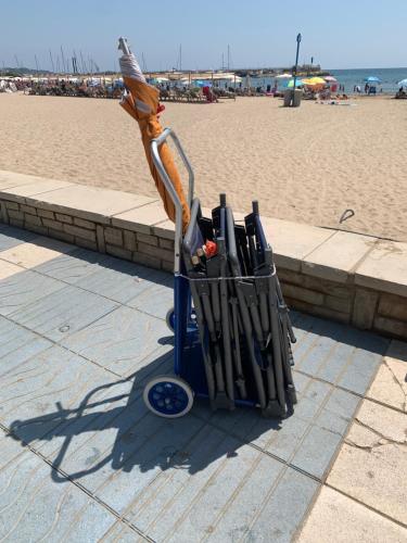 a group of umbrellas in a stand on the beach at SOLIMAR 10 SALOU Solo FAMILIAS con Parking y piscina in Salou