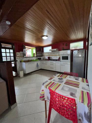 a kitchen with a table and chairs in a room at Chez Marie André et Jeanne in Grande Anse