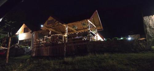 a house at night with the lights on at Bungalows Malagić in Gusinje
