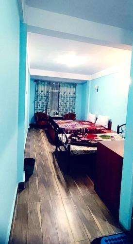 a room with a bed and a table in it at Hotel Little Hut - 550 mts from Mall Road in Darjeeling