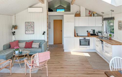 a kitchen and living room with a couch and a table at Nice Home In Kalundborg in Kalundborg