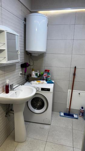 a bathroom with a washing machine and a sink at The Urban Nest Central Skopje Cozy 2BR Ap in Skopje