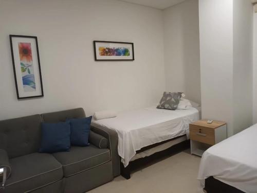 a living room with a couch and a bed at APARTAMENTO VISTA AL MAR WIND 906 in Gaira