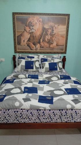 a bedroom with a bed with a painting on the wall at Recanto Marina in Paraty