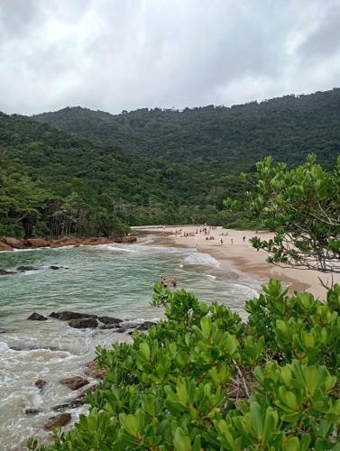 a group of people standing on a beach at Recanto Marina in Paraty