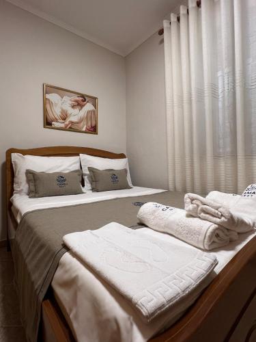 two twin beds in a bedroom with a window at Camaj Nest in Gjirokastër