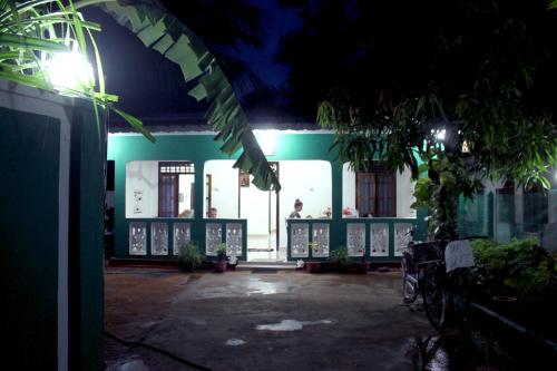 a building at night with a person in the distance at Alass Ga For Pets Lovers in Trincomalee