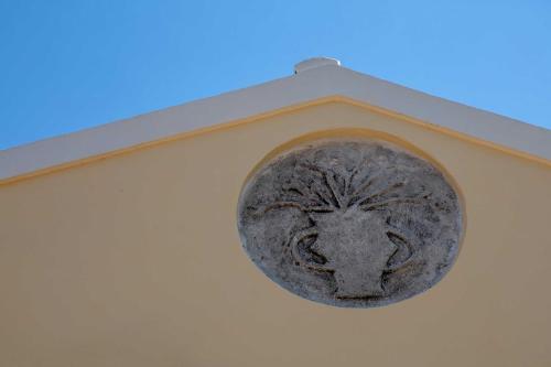 a stone lion head on the side of a building at Casabella in Arkadádes