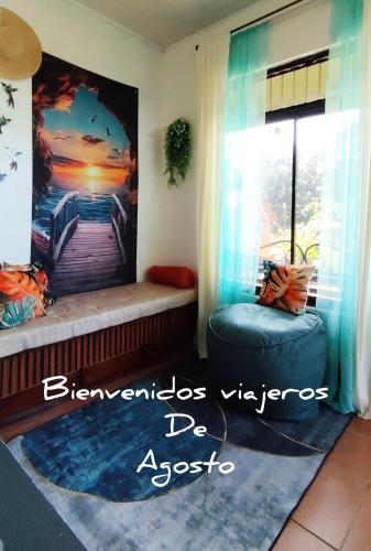 a room with a window seat with a painting on the wall at La casita de Nana in Esparza