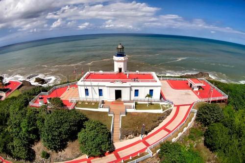 an aerial view of a lighthouse on the beach at Ventana Va102b at Arecibo 681 Ocean Drive in Arecibo