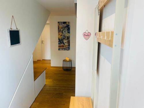 a hallway with white walls and a stair case at WS Ferienwohnung in Wolfurt